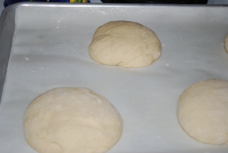 Hand shaped dough balls ready to be covered and left to rest for 10 minutes.